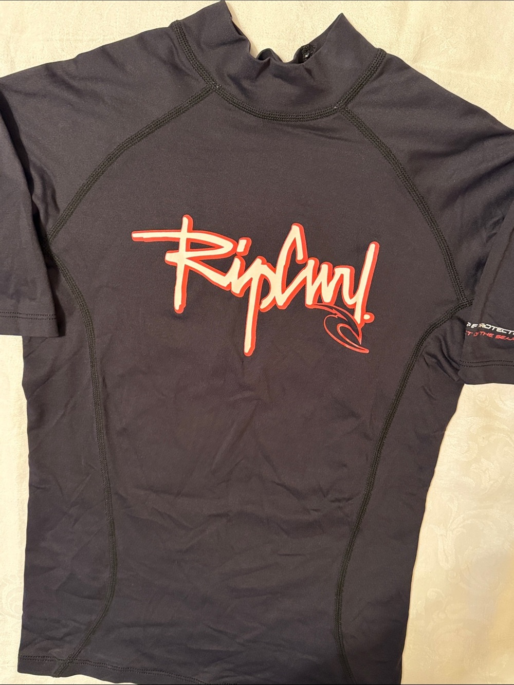 Rip Curl Black Short-Sleeve Rash Guard with Red and White Logo Script